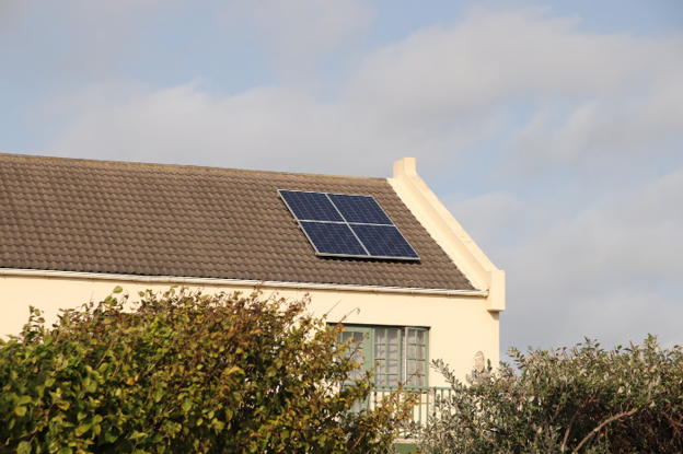 Residential property with rooftop solar panels demonstrating how solar energy benefits the environment.