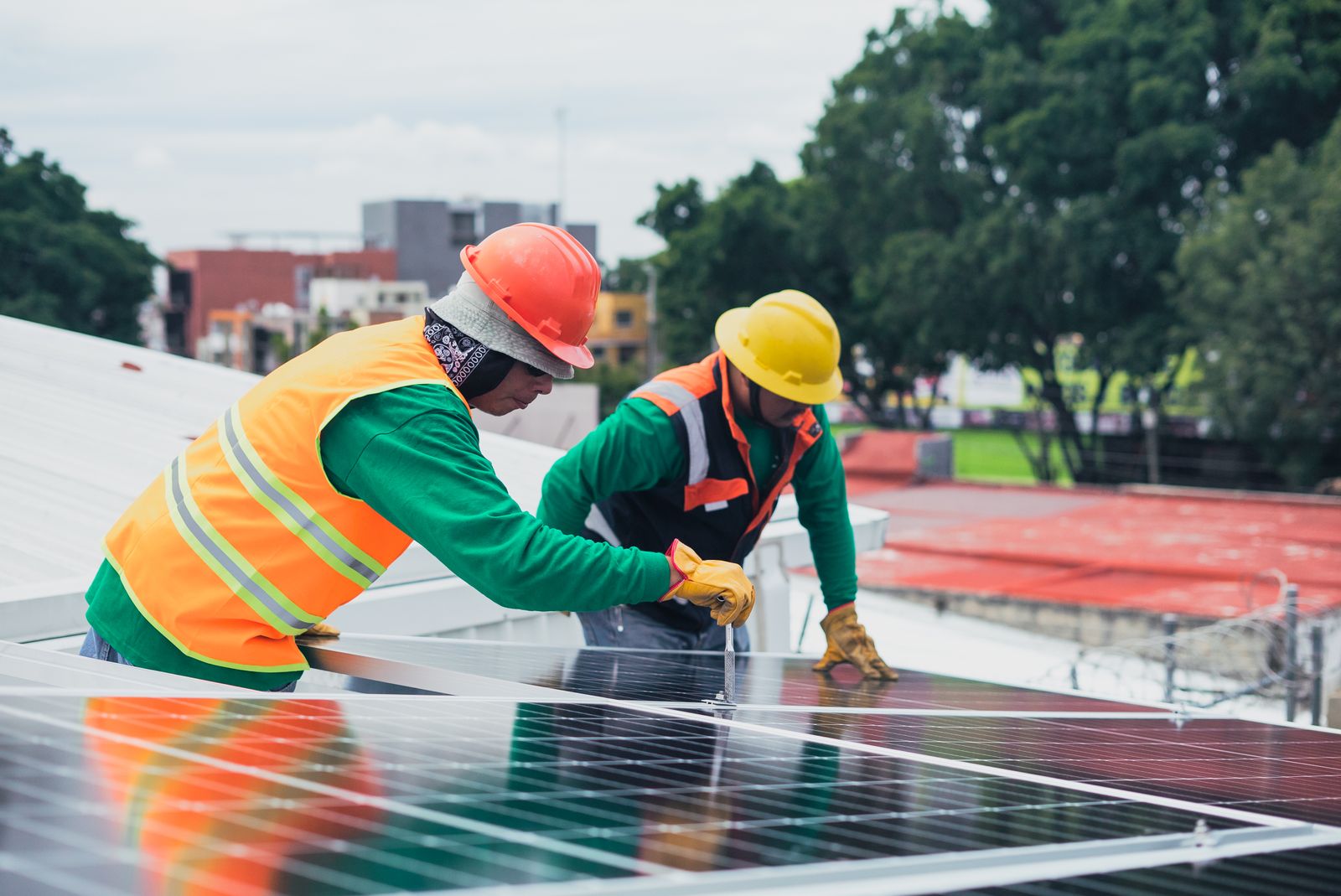 Professional contractors carrying out solar PV installation for business on a commercial property